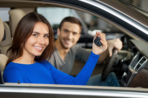 Woman holding keys to car